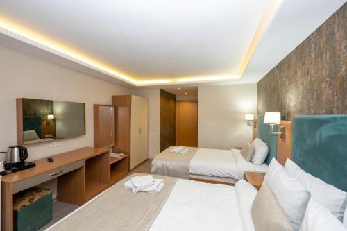 a hotel room with a bed and a desk at Hotel Devman in Istanbul