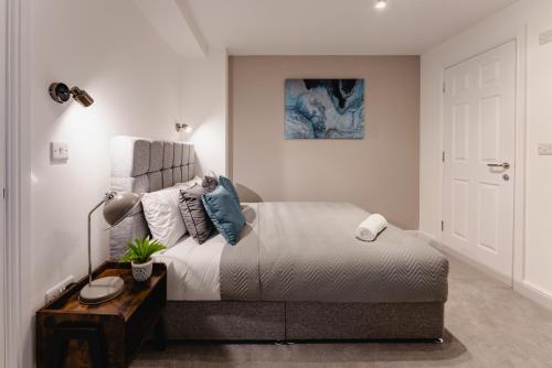 a bedroom with a large bed and a table at Prescott Court Serviced Apartments in Halifax