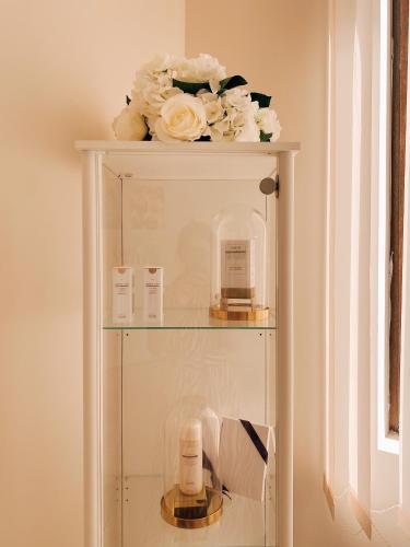 a glass shelf with flowers on top of it at Primoretz Grand Hotel & Spa in Burgas City
