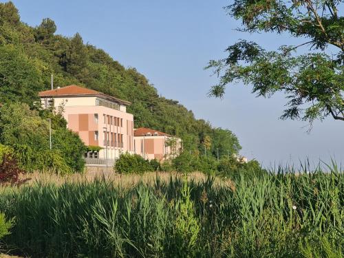 a building on the side of a hill at Hotel Lavender - Oleander Resort in Strunjan