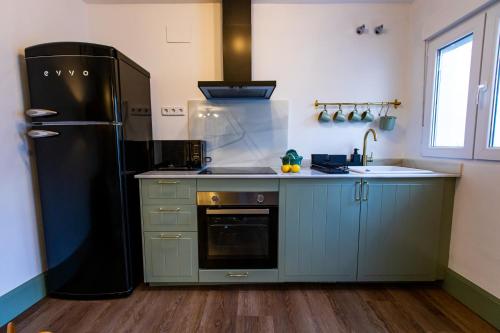 a kitchen with a refrigerator and a sink at HN Gaviota in Valencina de la Concepción