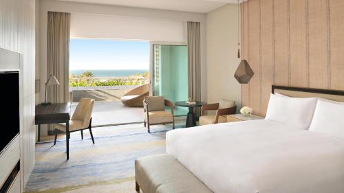 a hotel room with a bed and a view of the ocean at InterContinental Ras Al Khaimah Mina Al Arab Resort & Spa by IHG in Ras al Khaimah