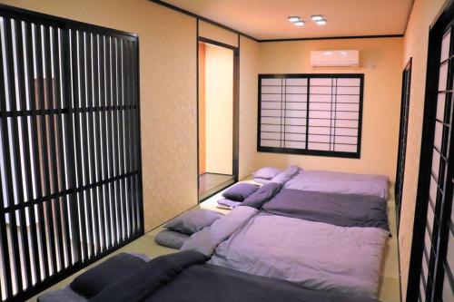 a bedroom with a large bed and a window at Linore in Ginowan