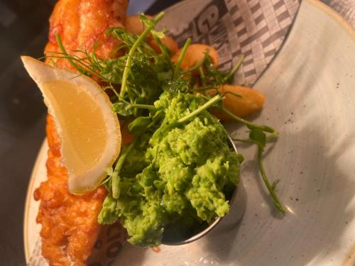 un plato de comida con una cuchara de guacamole en Red Lion Coaching Inn, en Ellesmere