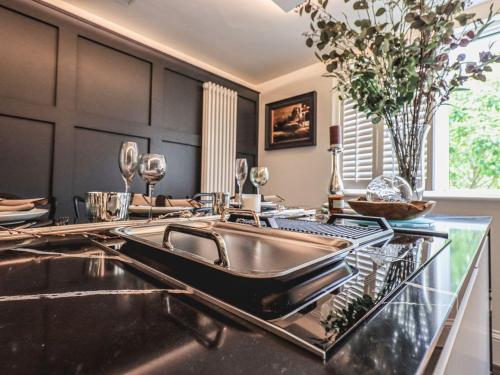 a kitchen with a sink on a counter at Whisk Away Cottage in Penrith