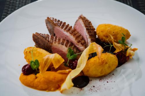 a plate of food on a white plate at Villa Csonka by Privo in Târgu-Mureş