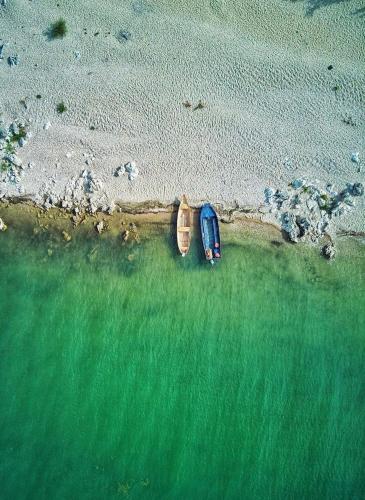 a car parked on the beach next to the water at Apartmani Konoba Starčevo in Virpazar