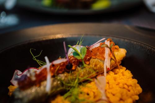 a plate of food with a piece of food at Villa Csonka by Privo in Târgu-Mureş