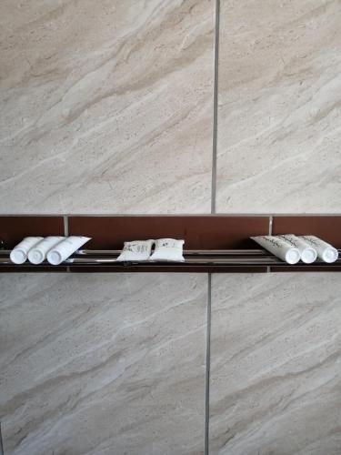 a shelf with three pairs of shoes on it at Beautiful & Serene Airbnb house in Klerksdorp