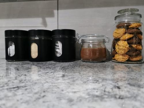 a group of jars filled with food on a counter at Beautiful & Serene Airbnb house in Klerksdorp