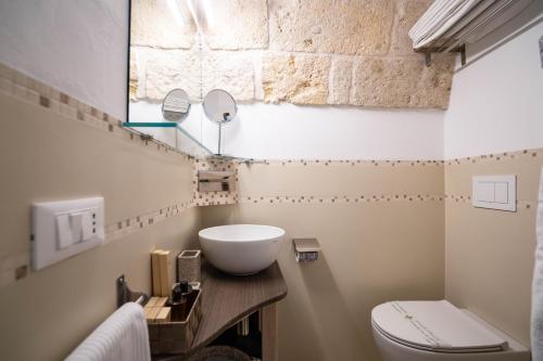 a bathroom with a sink and a toilet at Quintessenza Luxury Domus in Polignano a Mare