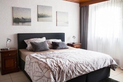 a bedroom with a bed with two pillows on it at Hotel zur Klause in Saarbrücken