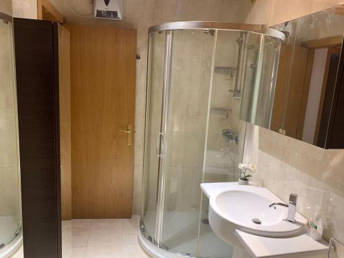 La salle de bains est pourvue d'une douche et d'un lavabo. dans l'établissement Agarimo das Burgas, à Ourense