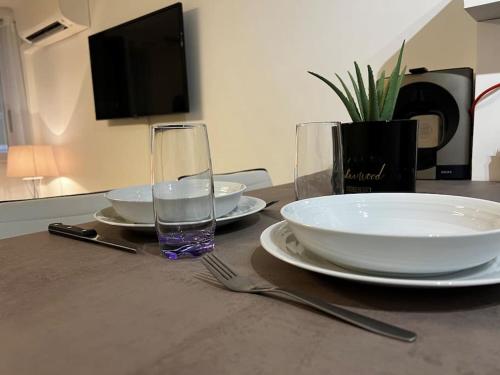 stół z płytkami i szklanką wody w obiekcie Chez Julien & Ornella w mieście Saint-Laurent-du-Var