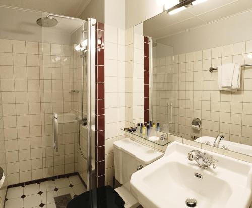 a bathroom with a sink and a shower at ProfilHotels Opera in Gothenburg