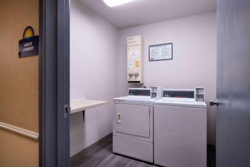 a laundry room with a washer and dryer at Days Inn by Wyndham Lathrop in Lathrop