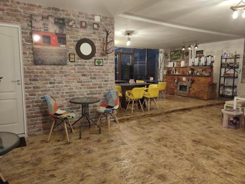 a room with chairs and a table and a brick wall at Cabana La Cassian in Vulcan