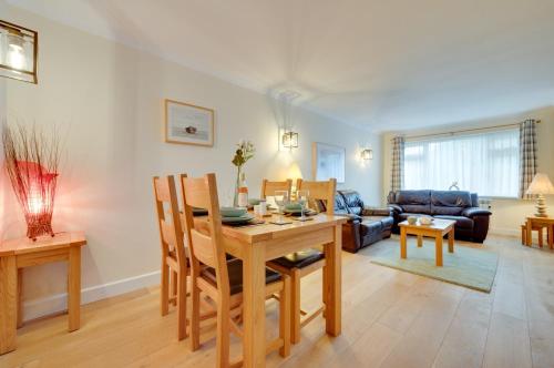 a living room with a table and a couch at Clover Cottage in Begelly