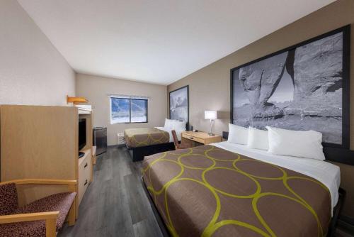 a hotel room with a large bed and a television at Super 8 by Wyndham Quartzsite AZ in Quartzsite