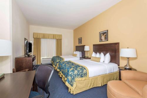 霍瑪的住宿－霍馬溫德姆溫蓋特酒店，酒店客房设有一张大床和一张书桌。