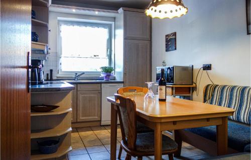 a kitchen with a wooden table and a dining room at 2 Bedroom Gorgeous Home In Uetze in Uetze