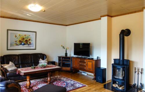 a living room with a couch and a wood stove at 2 Bedroom Gorgeous Home In Uetze in Uetze