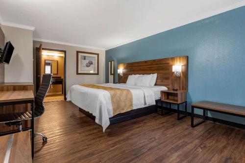 a hotel room with a bed and a desk at Quality Inn & Suites Ft Jackson Maingate in Columbia