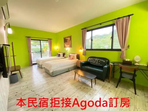 a bedroom with green walls and a bed and a chair at Starry Night in Taitung City