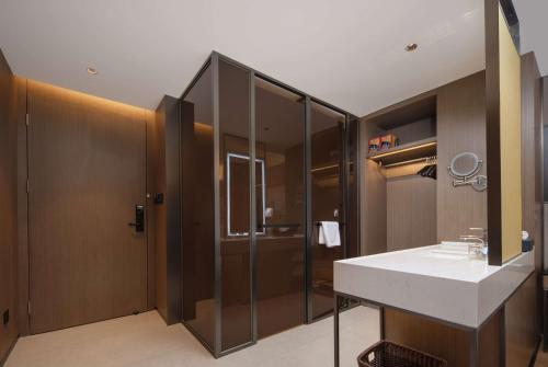 a bathroom with a sink and a shower at Days Hotel by Wyndham Chongqing Chenjiaping in Chongqing