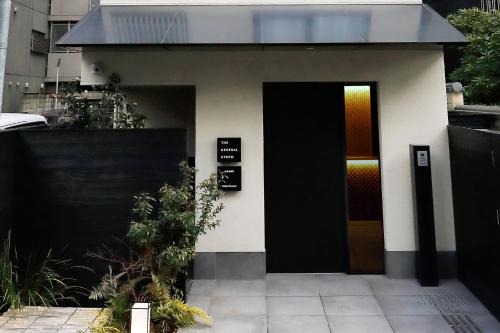 a black and white house with a black door at THE GENERAL KYOTO Bukkouji Shinmachi in Kyoto