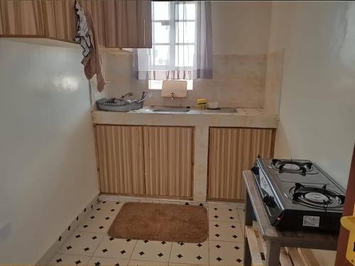 a small kitchen with a sink and a stove at Zuri Stays Machakos Town in Machakos