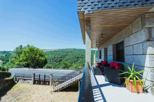 a house with a staircase leading to a swimming pool at Casa Ourense Guxinde in Pereira