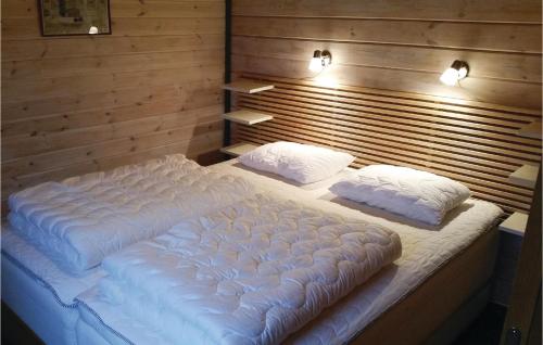 a large white bed with two pillows in a room at 2 Bedroom Awesome Home In Vetlanda in Vetlanda