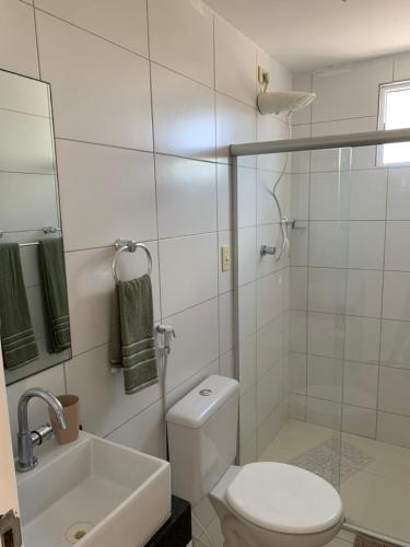 a bathroom with a toilet and a shower and a sink at Jóia Rara pertinho da Praia! in João Pessoa