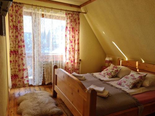 a bedroom with two beds and a window at Durda in Poronin