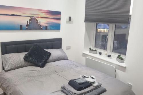 a bedroom with a bed with towels on it at Modern One-bedroom flat in Maidstone in Maidstone