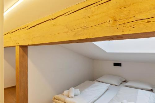 a bedroom with two beds and a wooden ceiling at Haus Excelsior Top 38 in Seefeld in Tirol