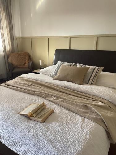 a bed with a tray with two wooden sticks on it at Gólyafészek Vendégház in Egerszalók