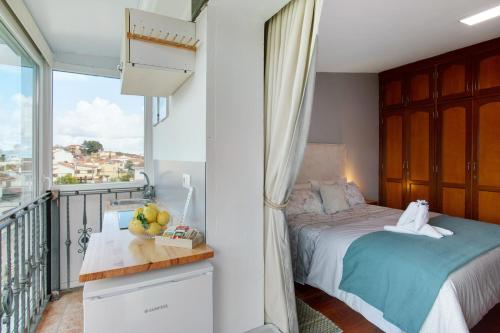 a bedroom with a bed and a balcony at Carmelo y Carmela 4 in Teror