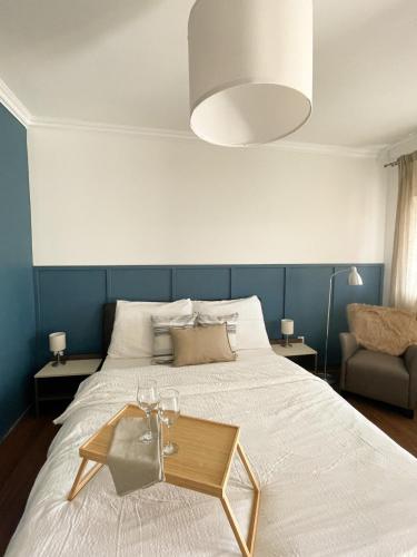 a bedroom with a large bed with a blue wall at Gólyafészek Vendégház in Egerszalók