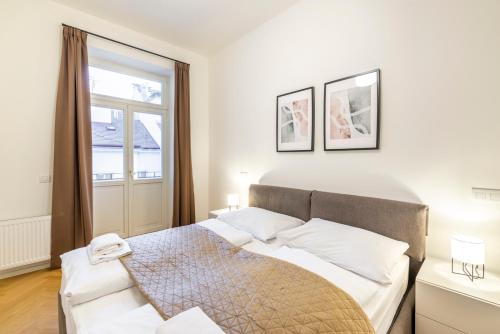 a bedroom with a bed and a window at Petrin Tower Residence in Prague