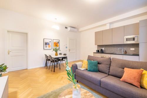 a living room with a couch and a table at Petrin Tower Residence in Prague