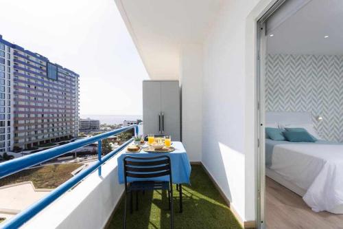 a balcony with a table and a bed in a room at Sunny Island Paraiso Sur in Adeje