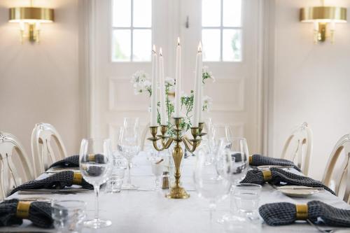 a dining room table with candles and wine glasses at Två Skyttlar in Örby