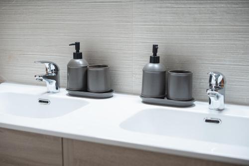 a bathroom sink with two soap dispensers on it at LT ATENEO in Bari