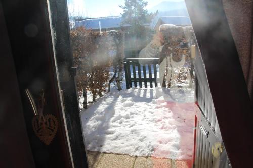 a person standing in the snow outside a door at LE COCON in Gresse-en-Vercors