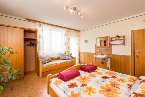 a bedroom with a bed and a sink in it at Gasthaus Bauer in Grafenschlag