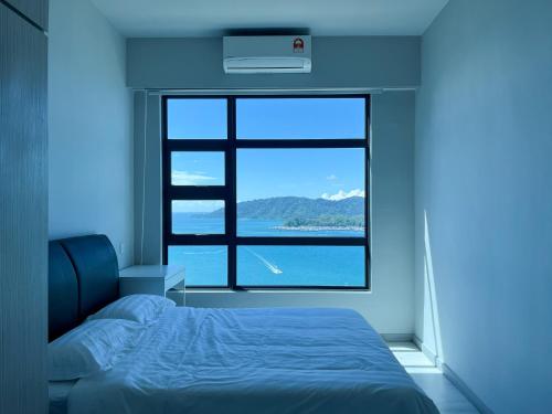 a bedroom with a bed and a large window at JESSELTON QUAY SEAVIEW Can Request LateCheckout 2pm in Kota Kinabalu