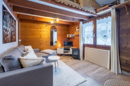 a living room with a couch and a table at Le Mazot - mezzanine with nice view in Chamonix-Mont-Blanc