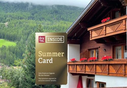 a sign in front of a building with a summer card at HAUS ERIKA apartments in Sölden